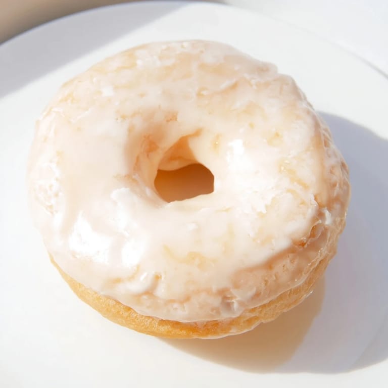 These homemade yeast donuts are pictured, freshly glazed and perfect for a delightful morning treat.