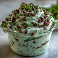 Creamy mint chocolate chip dip with shamrock sprinkles, perfect for St. Patrick's Day celebrations and festive gatherings.